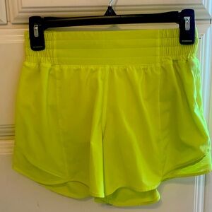Highlighter yellow 4 inch Lululemon hotty hot shorts.